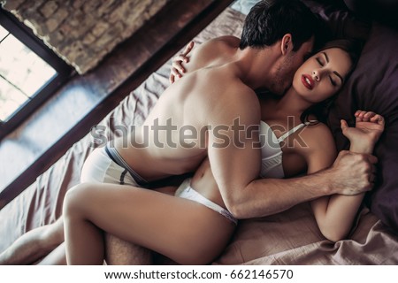 A girl and a boy having sex in bed