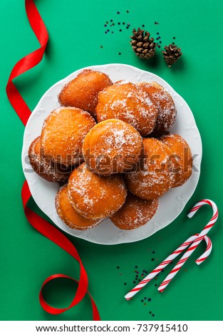 donuts filled with jam, marmalade or cream on a plate . festive New Year or Christmas style