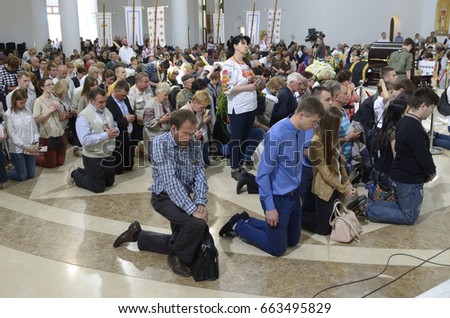 stock-photo-ukraine-kiev-june-crowd-of-parishioners-kneeling-and-praying-in-a-catholic-church-663495829.jpg