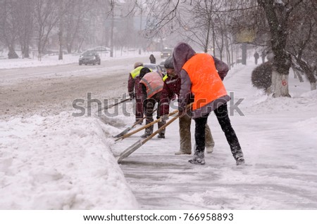 City after blizzard. Municipal workers removing snow and ice from streets of Kyiv. January 12, 2016. Kyiv, Ukraine.