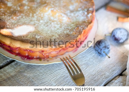 Rustic Plum Cake With Knife And Fork On White Wooden Background Rustic Plum Cake With Knife And Fork On White Wooden Background