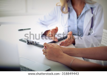 Doctor and patient are discussing something, just hands at the table