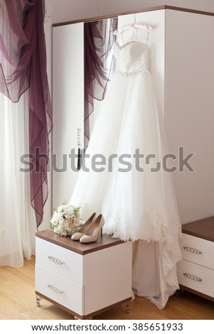 Bridal accessories: wedding dress, shoes and bride's bouquet