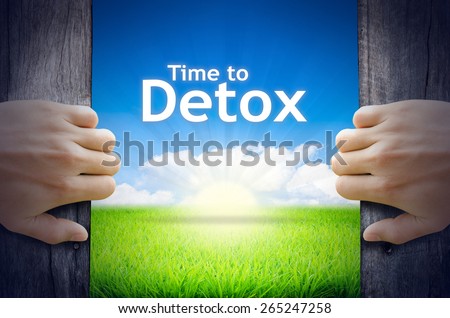 Time to Detox. Hands opening a wooden door then found a texts floating among new world as green grass field, Blue sky and the Sunrise.