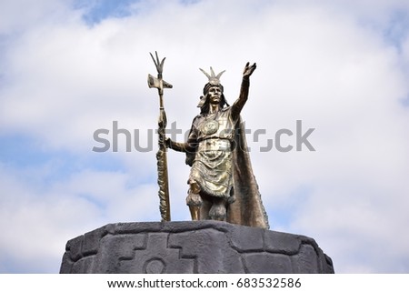 Inca statue standing high at a square in Cuzco Peru.