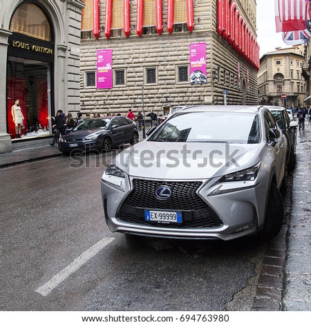 Florence, Italy: November 2016: A Lexus NX is parked near a Louis Vuitton clothing store. The new SUV was introduce to European market in 2014. The NX is available with hybrid version.