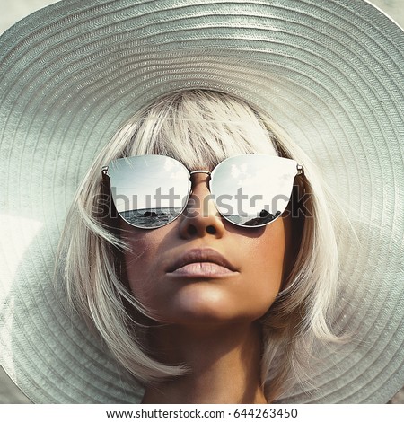 Outdoor fashion photo of young beautiful lady in hat and sunglasses. Summer Beach travel. Summer vibes