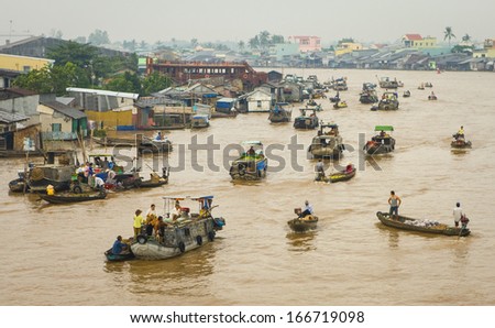 3 OCTOBER 2011 - CAN THO, VIETNAM - People on boats meet on the river at Can Tho to sell goods at the floating market, on 3 October 2011, in the Mekong Delta, Vietnam