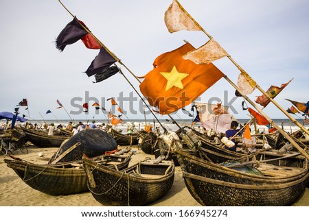 CIRCA JULY 2011 - THANH HOA, VIETNAM - Flags fly from fishing boats on Sam Son Beach, on 1 July 2011, in Thanh Hoa, Vietnam