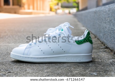 BANGKOK, THAILAND - JULY 2, 2017: Adidas stan smith classic shoes on ground stone outdoor popular fashion thailand.