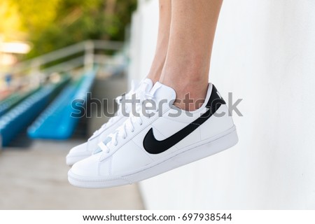 NAKHON PRATHOM, THAILAND - AUGUST 12, 2017:The woman wearing Nike tennis classic white/black shoes ,Nike, Inc. is an American multinational corporation that designs, develops, manufactures and sells tennis shoes.
