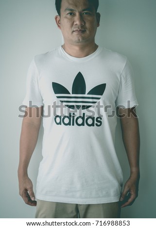 BANGKOK, THAILAND - JULY 9, 2017: Adidas logo on man T-shirt. Adidas is German designer and manufacturer of sports clothing and accessories; largest in Europe and 2nd biggest in the world.