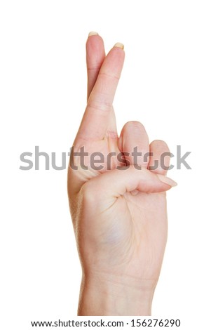 Hand promising an oath with two fingers crossed - stock photo