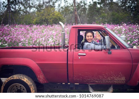 Hello Gardener Woman Smiling And Shows Gesture Of Greeting In Red Pickup Trucks Asian Hello Gardener Woman Smiling And Shows Gesture Of Greeting In Red Pickup Trucks Asian