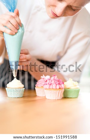 Woman Decorating Cupcakes piping icing stock images, royalty-free images & vectors Woman Decorating Cupcakes piping icing stock images, royalty-free images & vectors