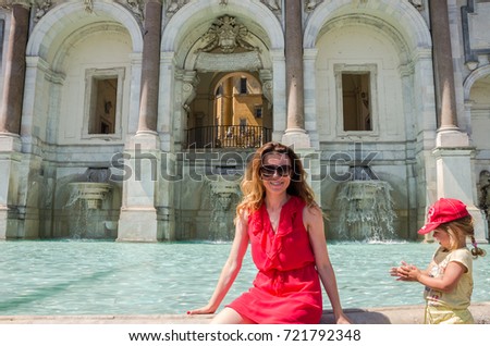 https://thumb1.shutterstock.com/display_pic_with_logo/1844540/721792348/stock-photo-young-beautiful-woman-mother-and-daughter-on-the-aqua-paola-fountain-in-rome-italy-721792348.jpg