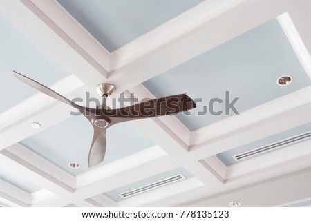 stock photo a large interior fan on a blue coffered ceiling 778135123