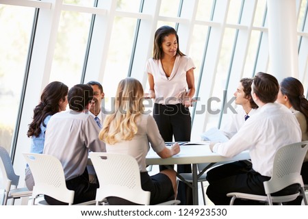 Business People Having Board Meeting In Modern Office