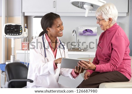Doctor Discussing Records With Senior Female Patient