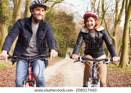 Couple On Cycle Ride In Winter Countryside