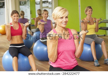 Women Taking Part In Gym Fitness Class
