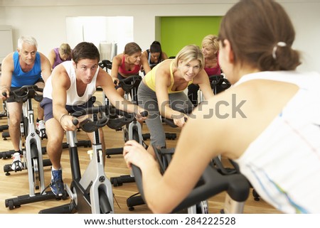 Group Taking Part In Spinning Class In Gym