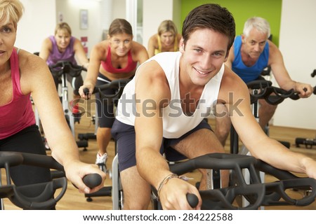 Group Taking Part In Spinning Class In Gym
