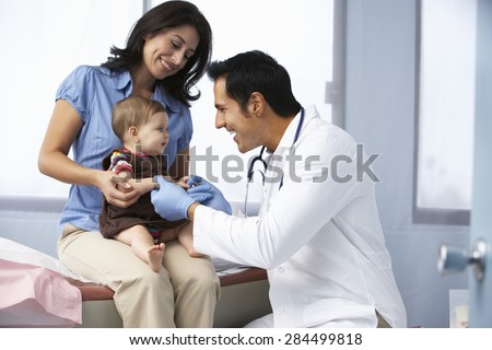 Doctor In Surgery Examining Baby Girl
