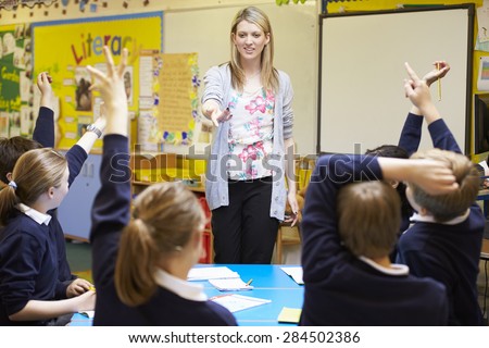 Teacher Teaching Lesson To Elementary School Pupils