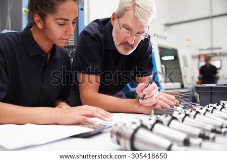 Engineer And Apprentice Planning CNC Machinery Project