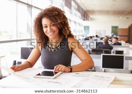 Young African American female architect working in an office