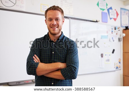 Portrait of confident Caucasian male teacher in classroom