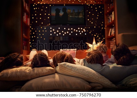 Family Enjoying Movie Night At Home Together