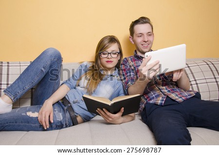 https://thumb1.shutterstock.com/display_pic_with_logo/1905920/275698787/stock-photo-couple-spending-free-time-together-girl-reading-a-book-while-her-boyfriend-is-using-tablet-275698787.jpg