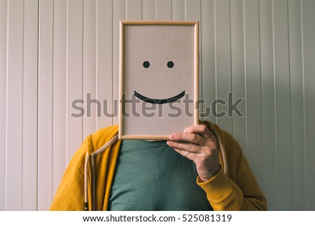 stock-photo-put-a-happy-optimistic-face-on-happiness-and-cheerful-emotions-concept-man-holding-picture-frame-525081319.jpg