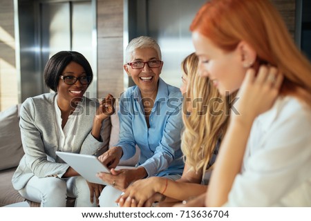 Happy business woman working together online on a tablet.