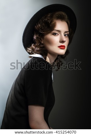 https://thumb1.shutterstock.com/display_pic_with_logo/1936208/415254070/stock-photo-retro-classic-portrait-of-elegant-woman-in-black-hat-and-dress-red-lips-wavy-hairstyle-415254070.jpg
