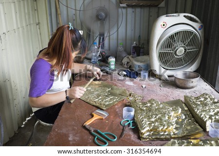 Bac Ninh, Vietnam - Sep 12, 2015: Junior craftsmen making copper handicraft products in traditional way (hand work) in Dai Bai village. Junior people are major labors in traditional works in Vietnam.