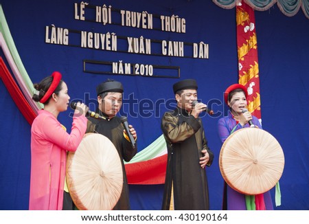 Bac Ninh, Vietnam - Mar 24, 2010: Vietnamese popular civilian artist in traditional costume singing traditional melody called Quan Ho Bac Ninh in occasion of a local folk free entrance festival day.