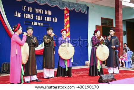 Bac Ninh, Vietnam - Mar 24, 2010: Vietnamese popular civilian artist in traditional costume singing traditional melody called Quan Ho Bac Ninh in occasion of a local folk free entrance festival day.