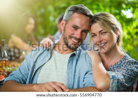 https://thumb1.shutterstock.com/display_pic_with_logo/1946624/556904770/stock-photo-summertime-portrait-of-a-beautiful-couple-looking-at-the-camera-they-are-sitting-with-friends-556904770.jpg