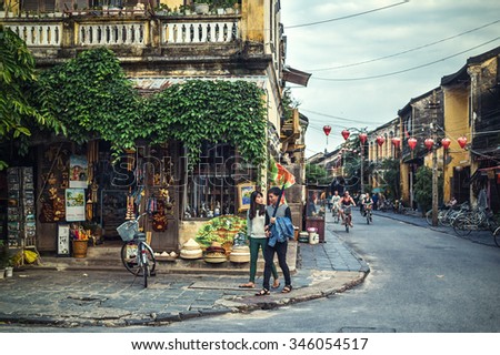 HOI AN, VIETNAM - November 14: couple walking on the streets of Hoi An, Vietnam on Apirl 14, 2014 in Hoi An. Hoi An, a UNESCO World Heritage site, is a major touristic destination in Central Vietnam.