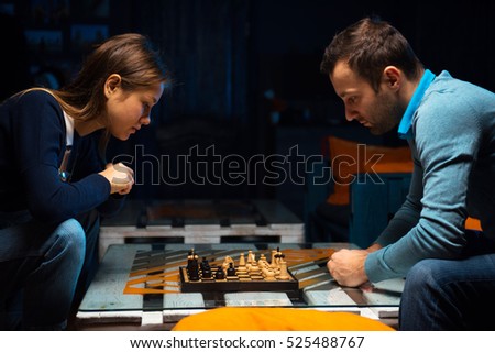 Young people playing chess in the games room