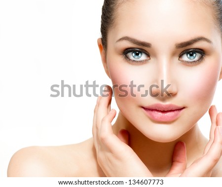 Beauty Portrait. Beautiful Spa Woman Touching her Face. Perfect Fresh Skin. Isolated on White Background. Pure Beauty Model. Youth and Skin Care Concept