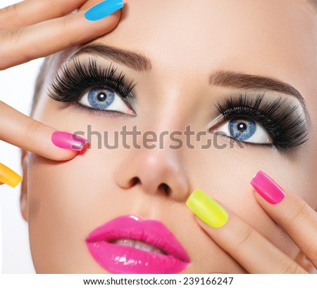 Beauty Girl Portrait with Vivid Makeup and colorful Nail polish. Colourful nails. Fashion Woman portrait close up. Bright Colors. Manicure Make up. Smoky eyes, long eyelashes. Rainbow Colors