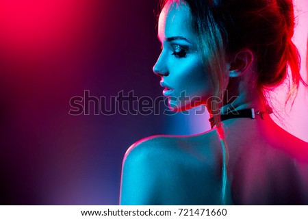 High Fashion model woman in colorful bright lights posing, portrait of beautiful girl with trendy make-up. Art design, colorful make up. Over colourful vivid background.
