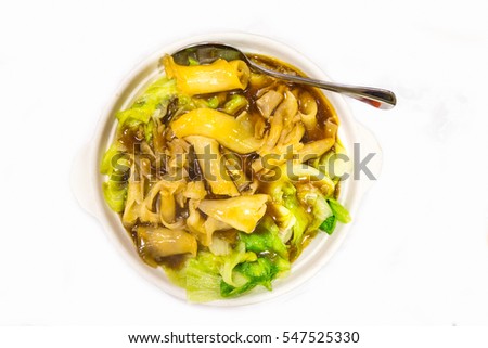 Chinese delicacy braised fish maw with vegetable served in bowl on table