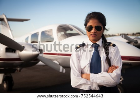 Female Pilot Standing in Front of Aircraft