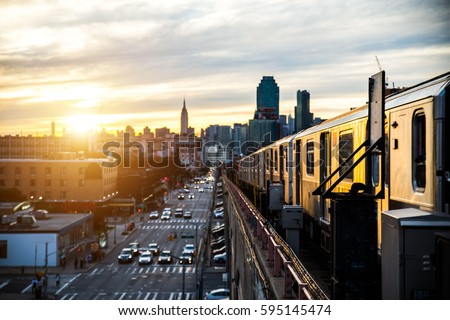 Subway train in New York at sunset and Manhattan cityscape view