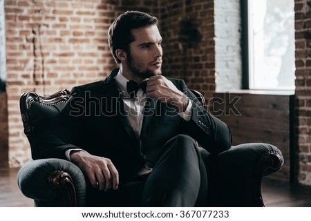 Handsome Choosing Bow Tie While Looking Away In Handsome Choosing Bow Tie While Looking Away In